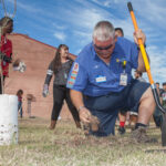 The Hamstra team and others planting a tree.